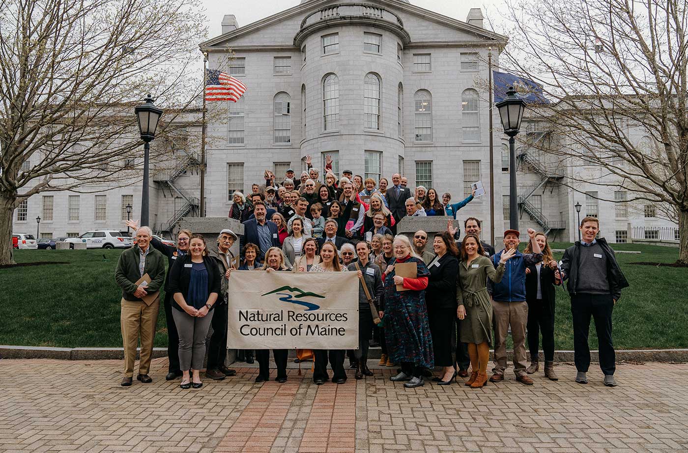 NRCM members standing on stairs with Maine State House behind them