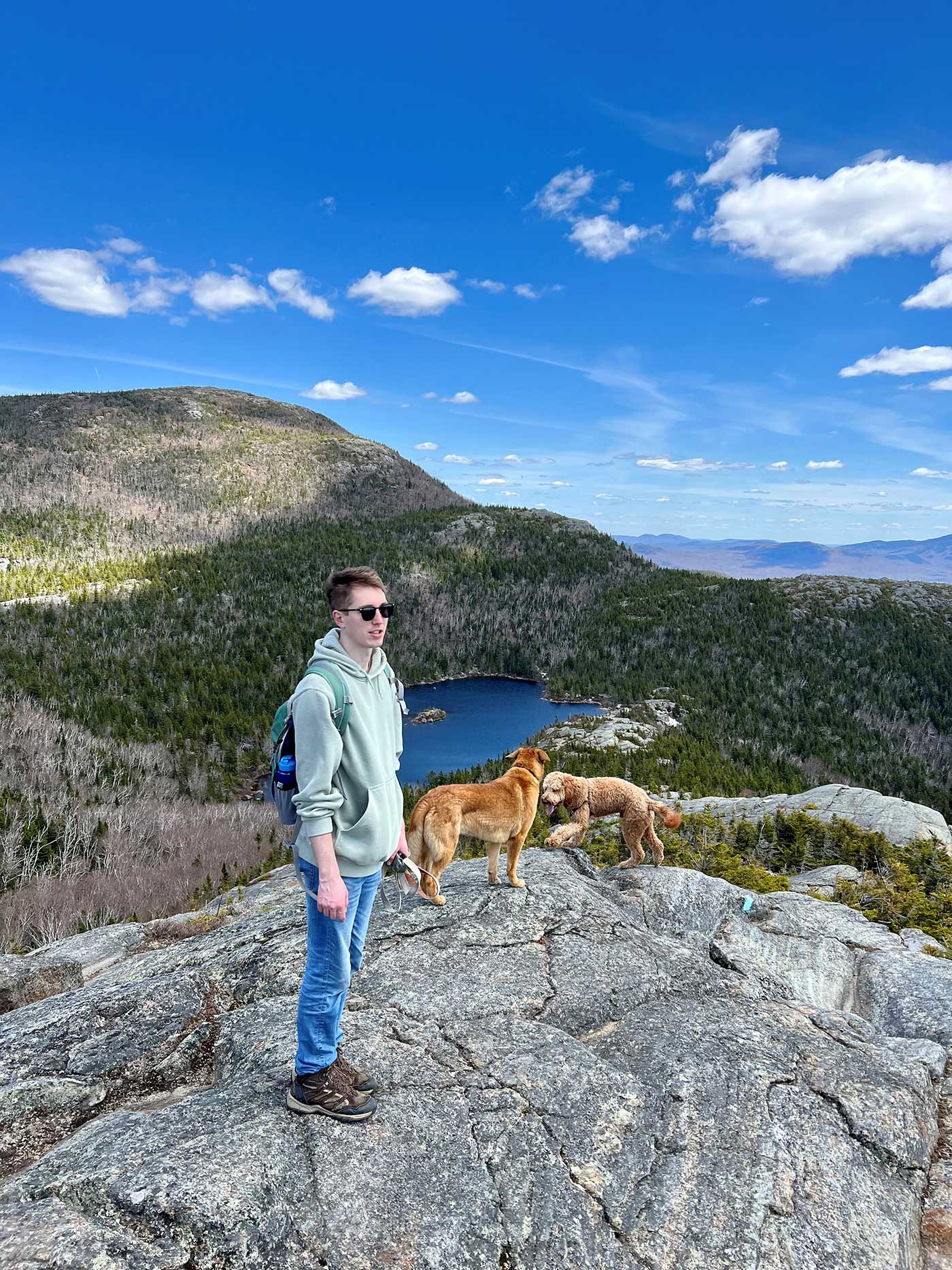 Man and two dogs next to pond on top of Tumbledown