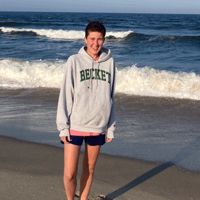 Lucia-pizarro Lucia standing on beach with ocean waves behind her