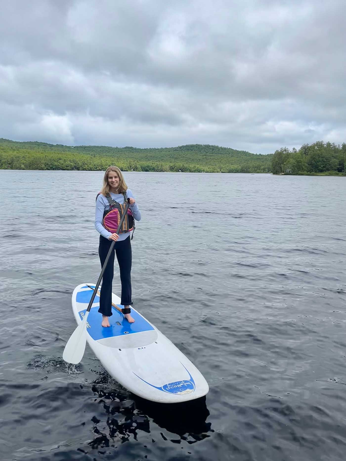 young woman standing on paddleboard
