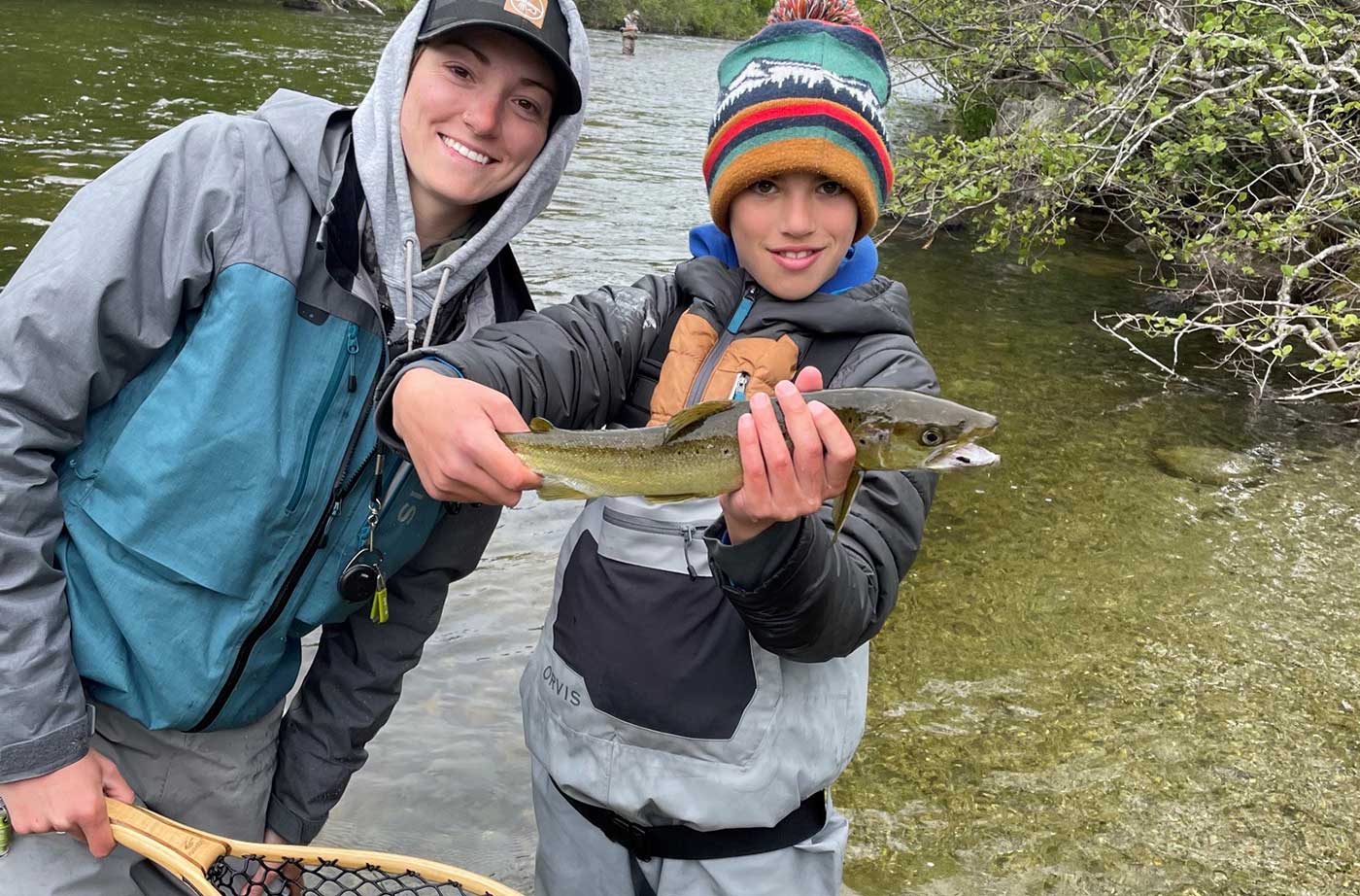 Keaton McEvoy with young boy holding fish