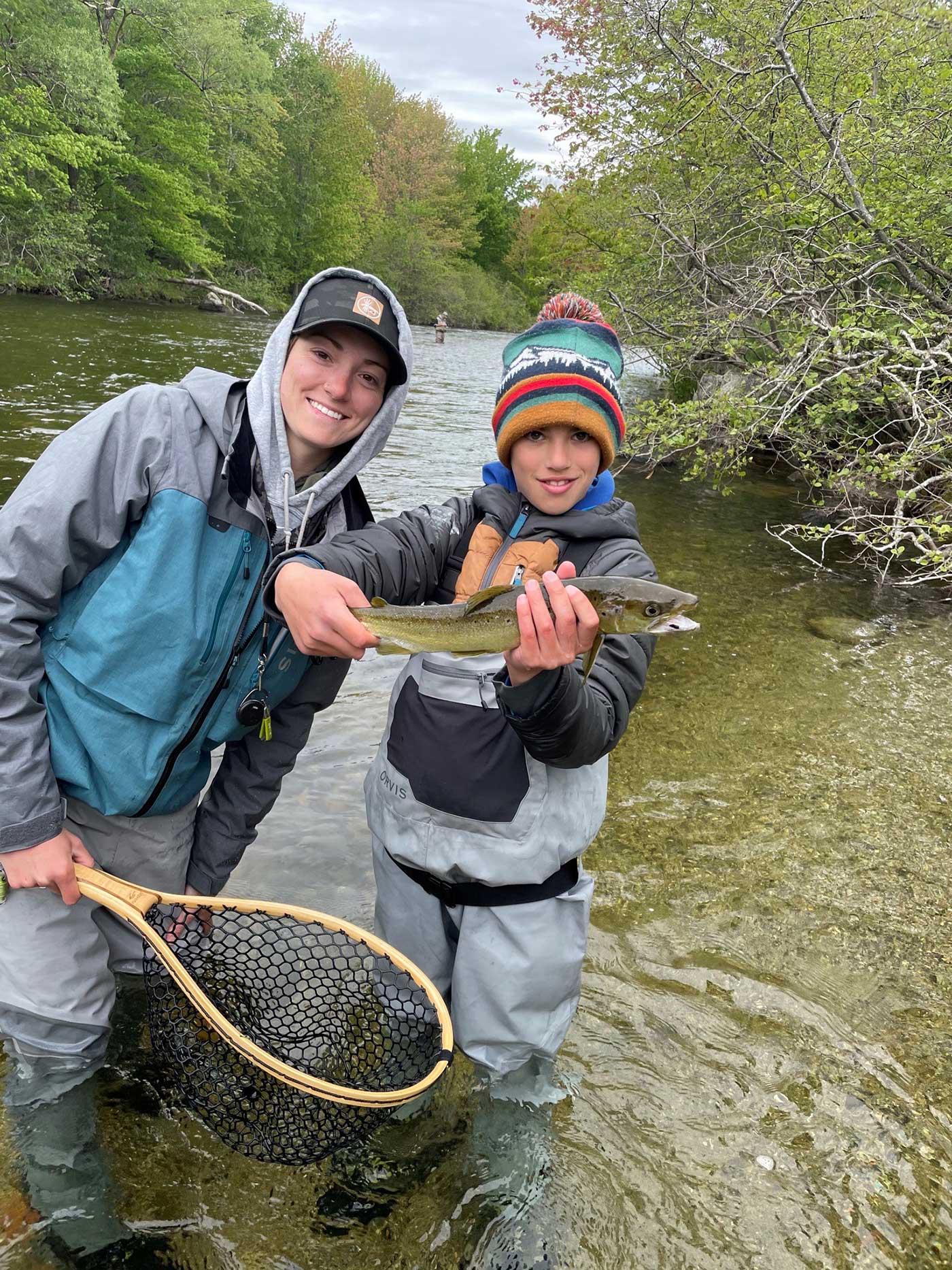 Keaton McEvoy with young boy holding fish