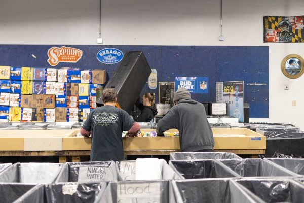 People sorting bottles at redemption center