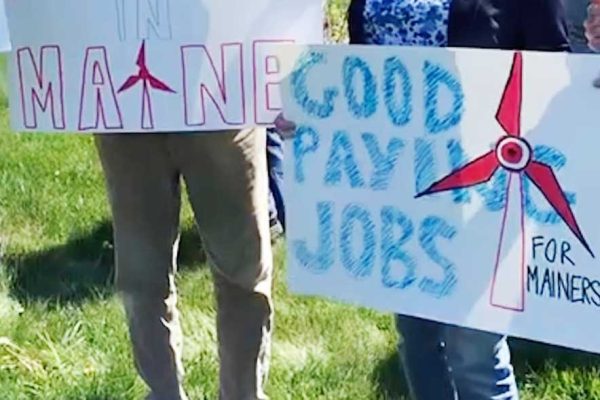 homemade signs in support of Maine offshore wind