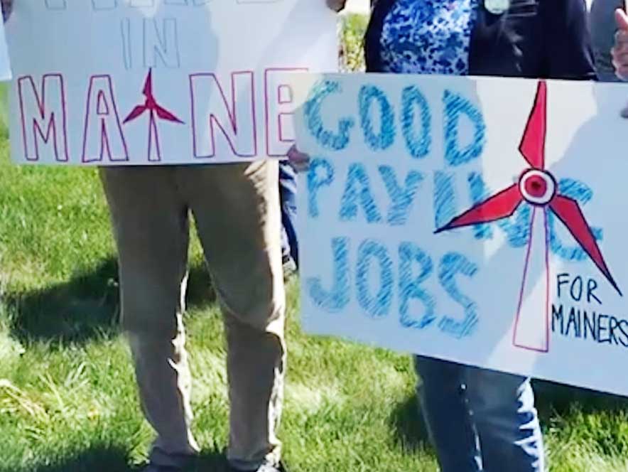 homemade signs in support of Maine offshore wind