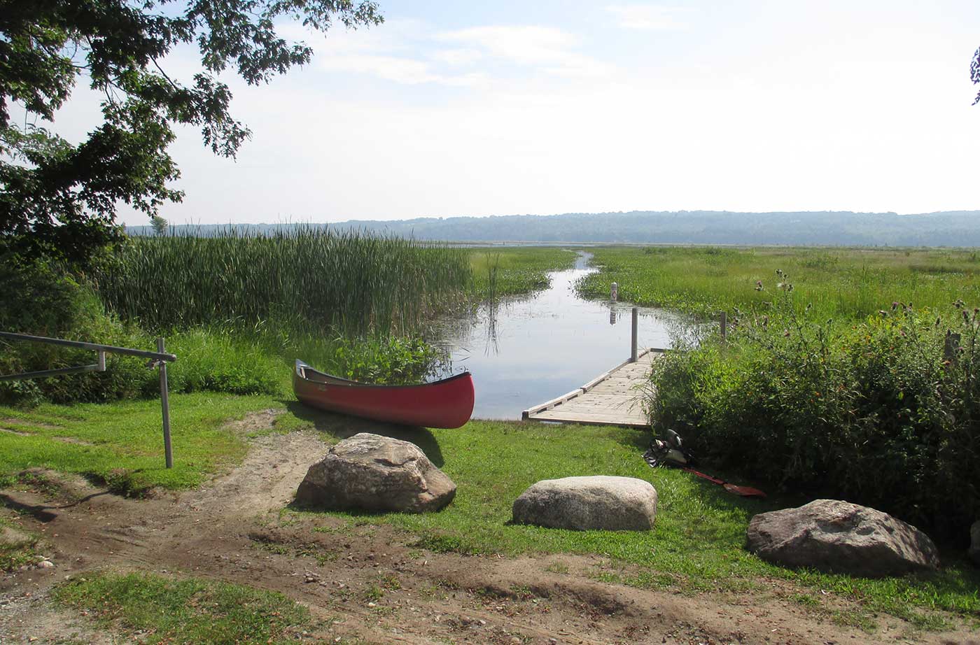 canoe on shore next to waterway