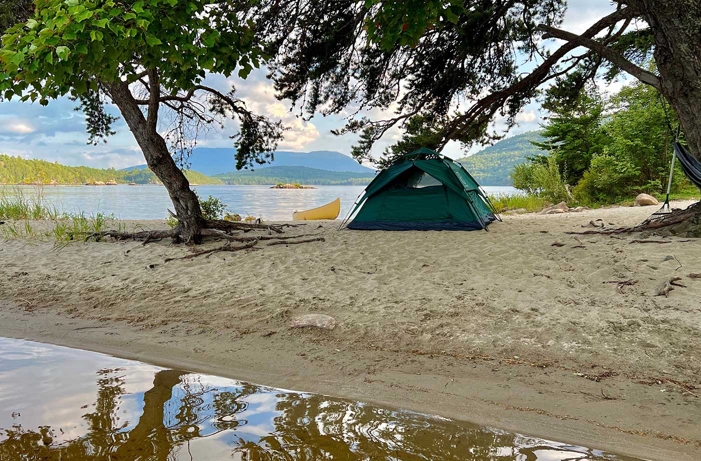 tent on beach on shore of lake