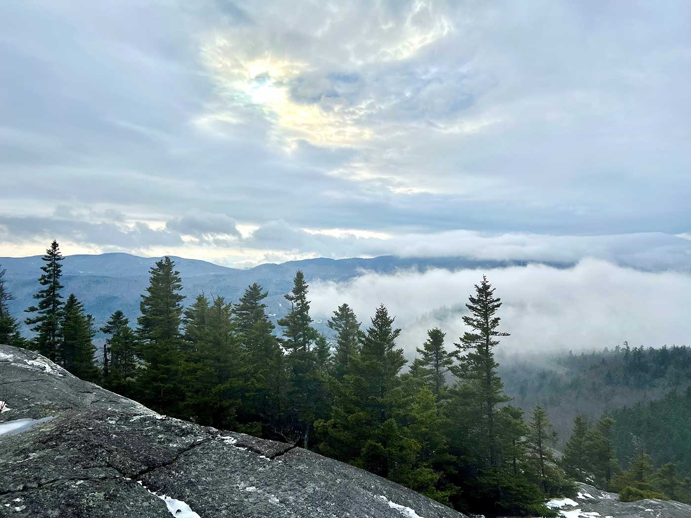 View from mountaintop of trees and clouds