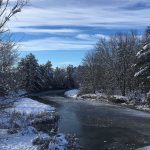 view of Sheepscot River with snow-covered trees lining it