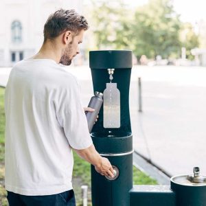 young person using water bottle fill station
