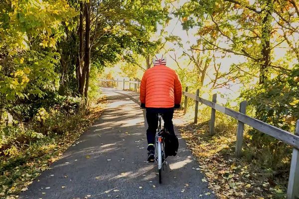 riding bike on trail through woods