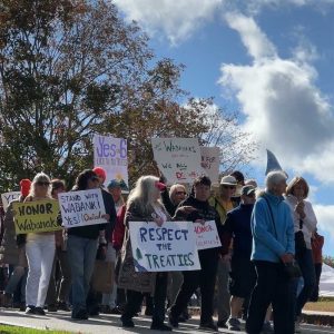 people marching with signs in support of tribal sovereignty