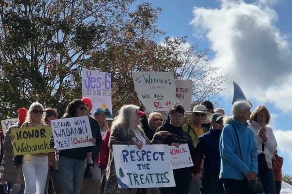 people marching with signs in support of tribal sovereignty