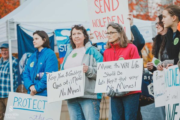 people holding signs opposing mine at Pickett Mountain