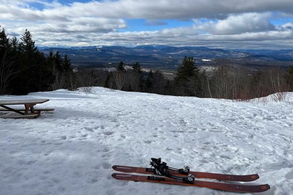 pair of skis on snow atop a mountain