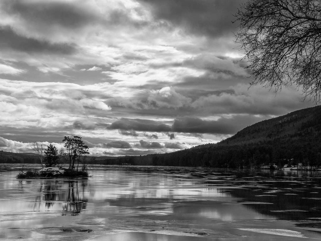 black and white photo of pond and clouds