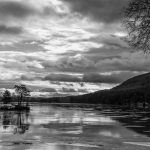 black and white photo of pond and clouds