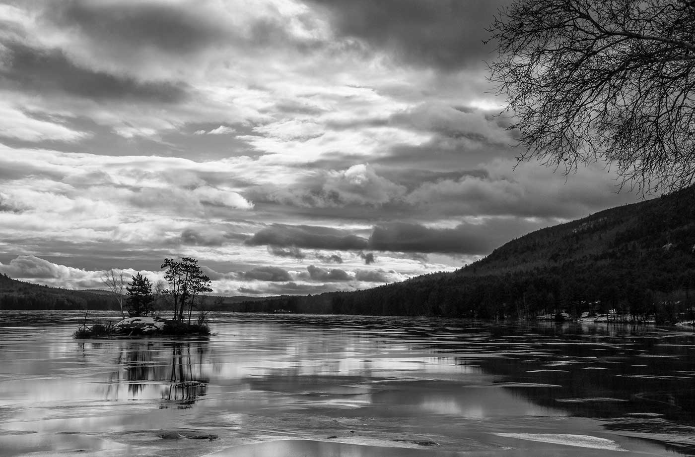 black and white photo of pond and clouds