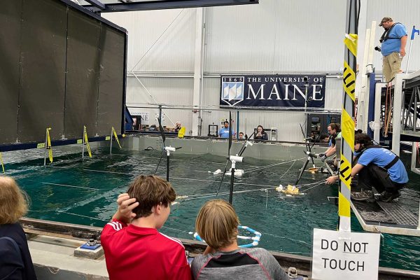 kids in front of testing pool for wind project at UMaine