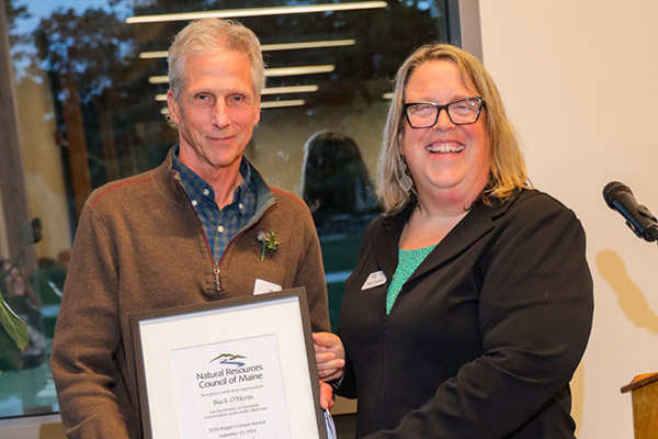 Two people holding framed award