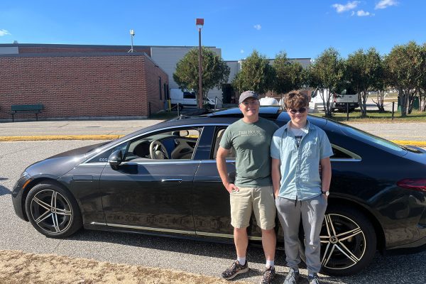 man and teenage son standing in front of Mercedes sedan