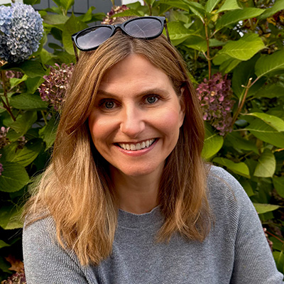 Vanessa LaVallee outdoors, smiling, sunglasses on head
