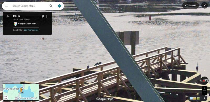 pigeons sitting on dock railing over water
