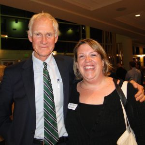 Brownie and Beth smiling at annual meeting inside Hannaford Hall