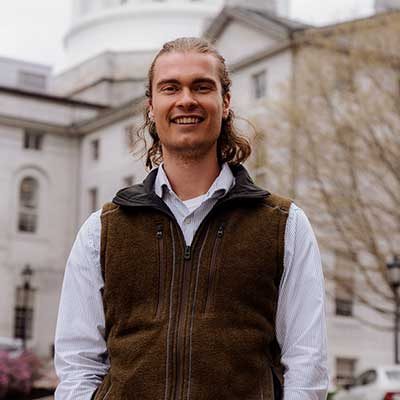 Josh Caldwell standing in front of State House