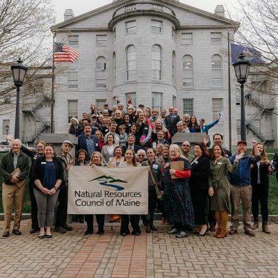State-House-Action-Day-2023_NRCMAlyssaPereira-(45) NRCM members standing on stairs with Maine State House behind them