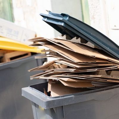 cardboard packaging in trash can